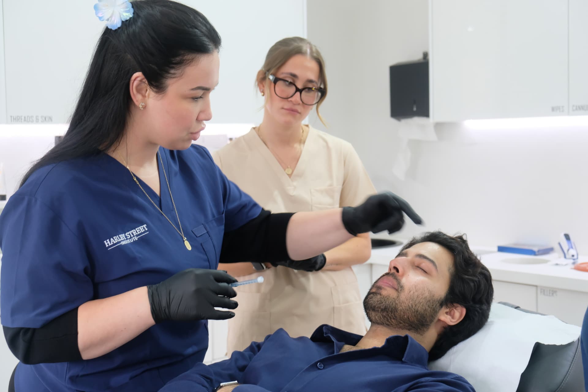 HSI practitioner marking a patient's lower face during a supervised training consultation at Harley Street Institute